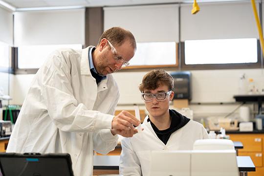 photo of two men conducting lab experiment